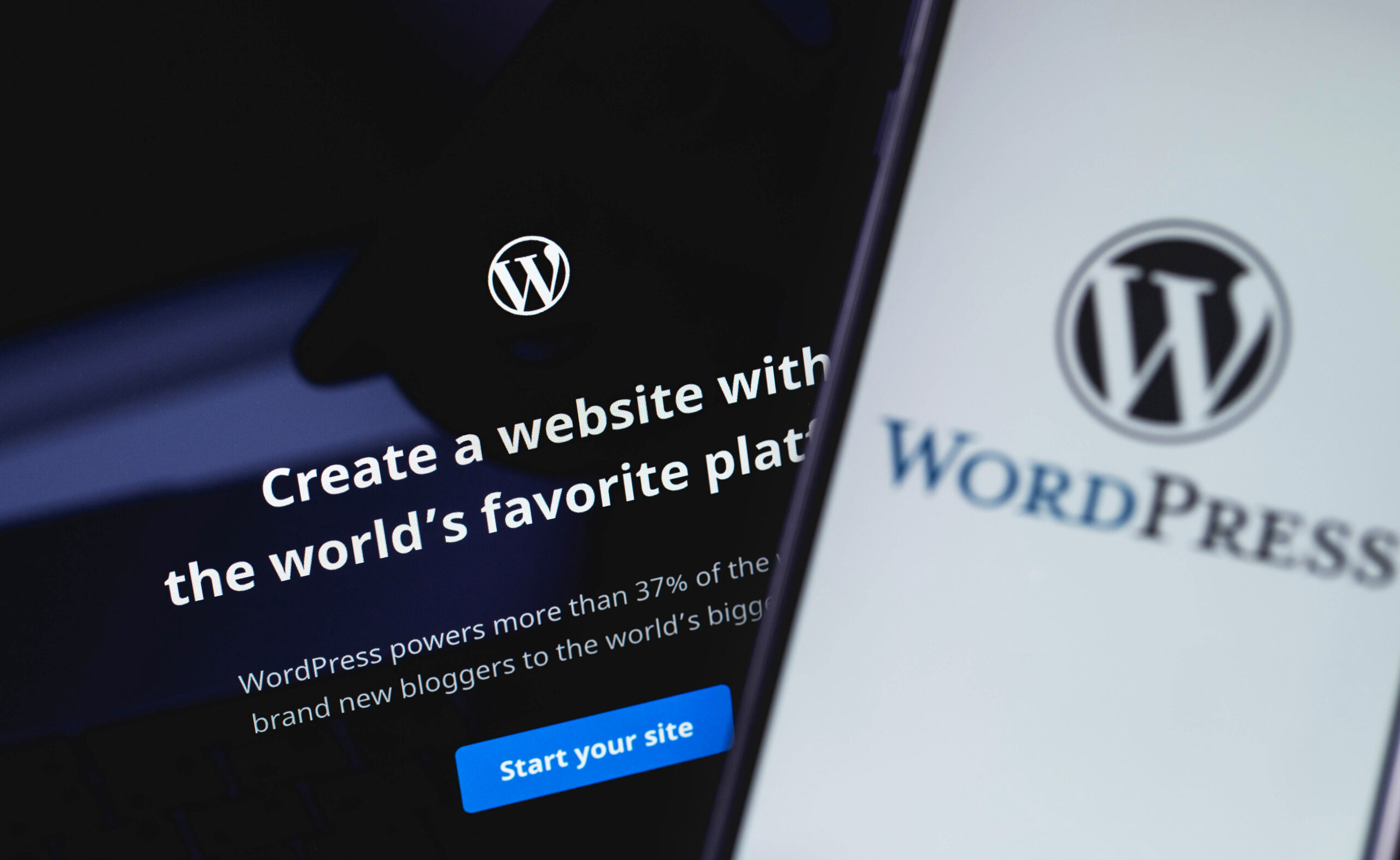 WordPress web page on the screen notebook and smartphone closeup